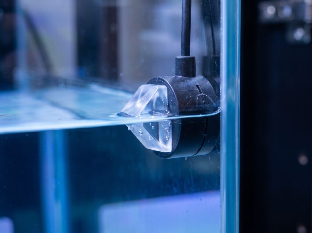 Optical water level sensor mounted at waterline in reef aquarium sump